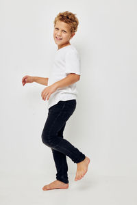 Portrait of smiling boy against white background