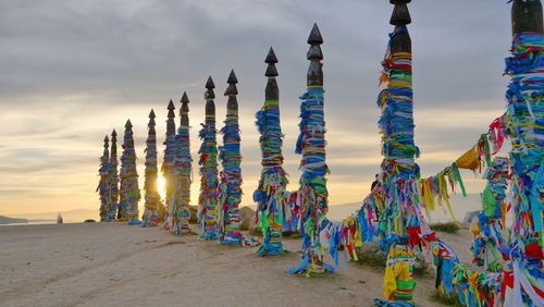 Multi colored umbrellas on beach against sky