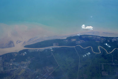 Aerial view of landscape and sea against sky