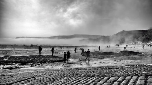 People on beach against sky