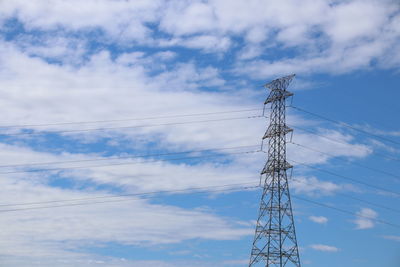 Low angle view of electricity pylon against sky