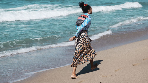 Woman with umbrella on beach