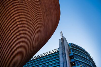 Low angle view of modern building against clear blue sky