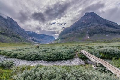 Scenic view of mountains against cloudy sky