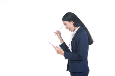 Side view of a young woman against white background