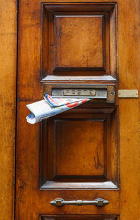 Close-up of mail slot of door