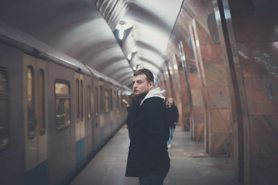 Rear view of man standing in train