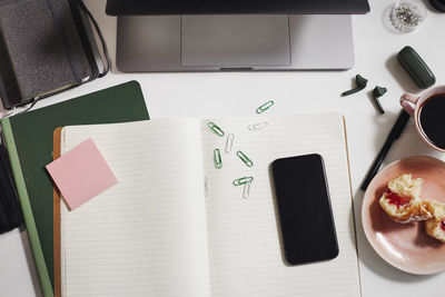 View of desk with diary and cell phone