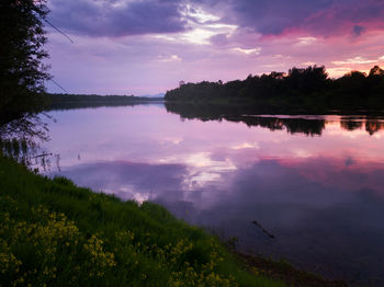 Scenic view of lake against sky at sunset