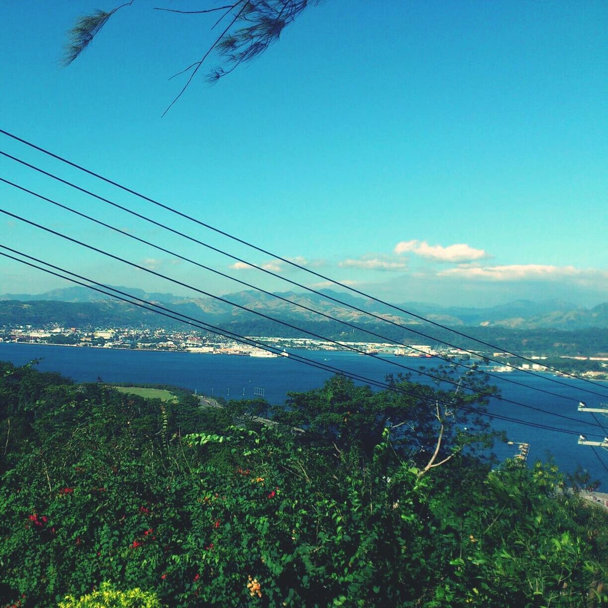 connection, suspension bridge, bridge - man made structure, blue, built structure, engineering, architecture, sky, transportation, clear sky, bridge, sea, copy space, water, mountain, river, outdoors, nature, cable, scenics