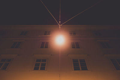 Illuminated building against sky