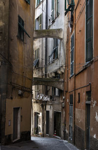 Empty narrow alley along buildings