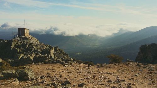 Scenic view of mountains against cloudy sky