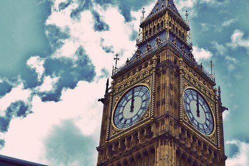 low angle view, architecture, clock, clock tower, time, built structure, sky, building exterior, tower, religion, church, place of worship, cloud - sky, spirituality, cloud, cathedral, clock face, famous place
