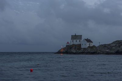 Scenic view of sea by building against sky