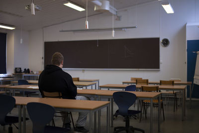 A lonely student in an empty classroom.