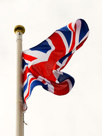 Low angle view of flag against clear sky