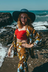 Portrait of fashionable woman standing on beach