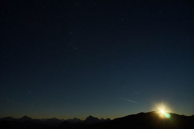 Scenic view of silhouette mountain against sky at night