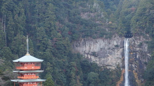 Built structure in forest against sky