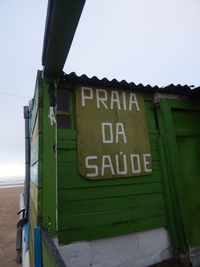 Close-up of information sign against clear sky