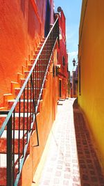 Alley amidst buildings in city against sky