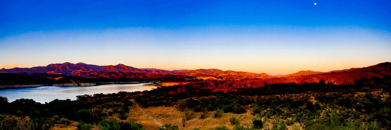 Scenic view of mountains against clear blue sky