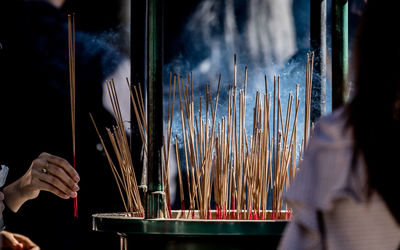 Woman adding incense offering in remembrance