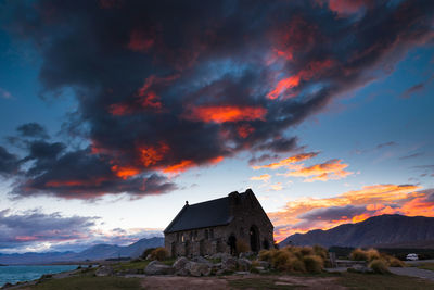 Built structure against cloudy sky at sunset