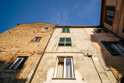 Low angle view of building against clear blue sky