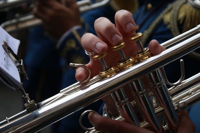 Cropped hand playing musical instrument