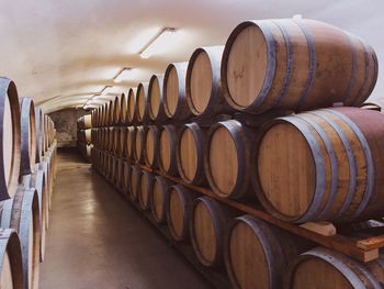 Stack of wine barrels inside a wine cellar 