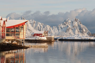 Scenic view of lake by buildings against sky