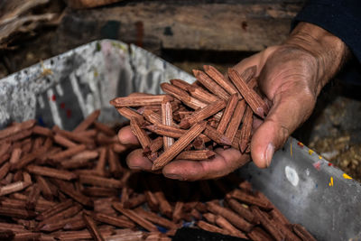 Cropped hand holding wooden objects