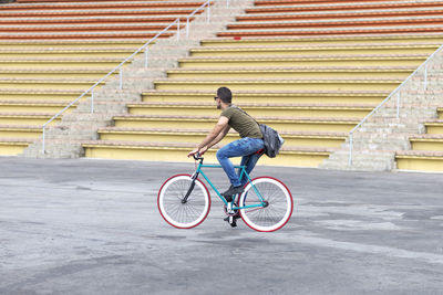 Low angle view of man riding bicycle on street