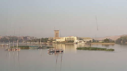 Sailboats in marina against clear sky