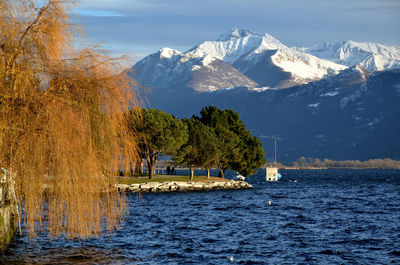 Scenic view of sea and mountains against sky