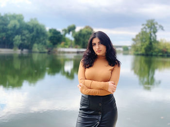 Portrait of young woman standing in lake