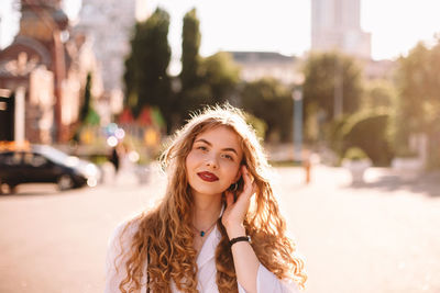 Portrait of beautiful young woman in city