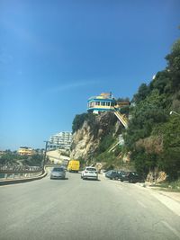 Cars on road against blue sky