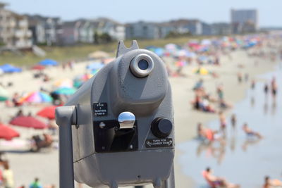 Close-up of coin-operated binoculars against sky