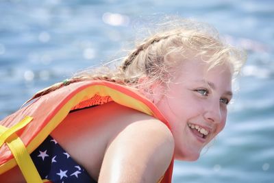 Smiling girl against sea