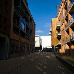 Street amidst buildings against sky in city