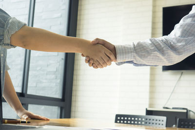 Cropped image of business people doing handshake