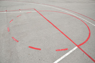 Part of basketball playground with red and white lines