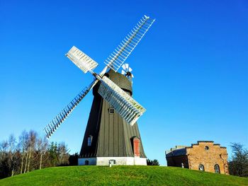 Low angle view of traditional windmill on hill