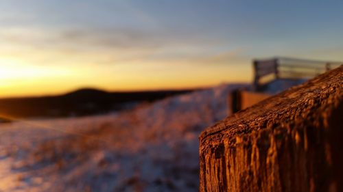 Close-up of stone wall at beach against sky