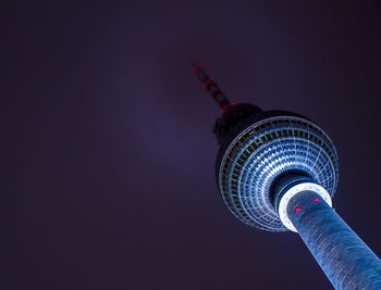 Low angle view of fernsehturm tower against sky at night