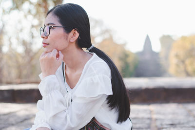 Young woman looking away outdoors