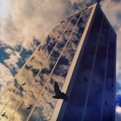 Low angle view of building against cloudy sky